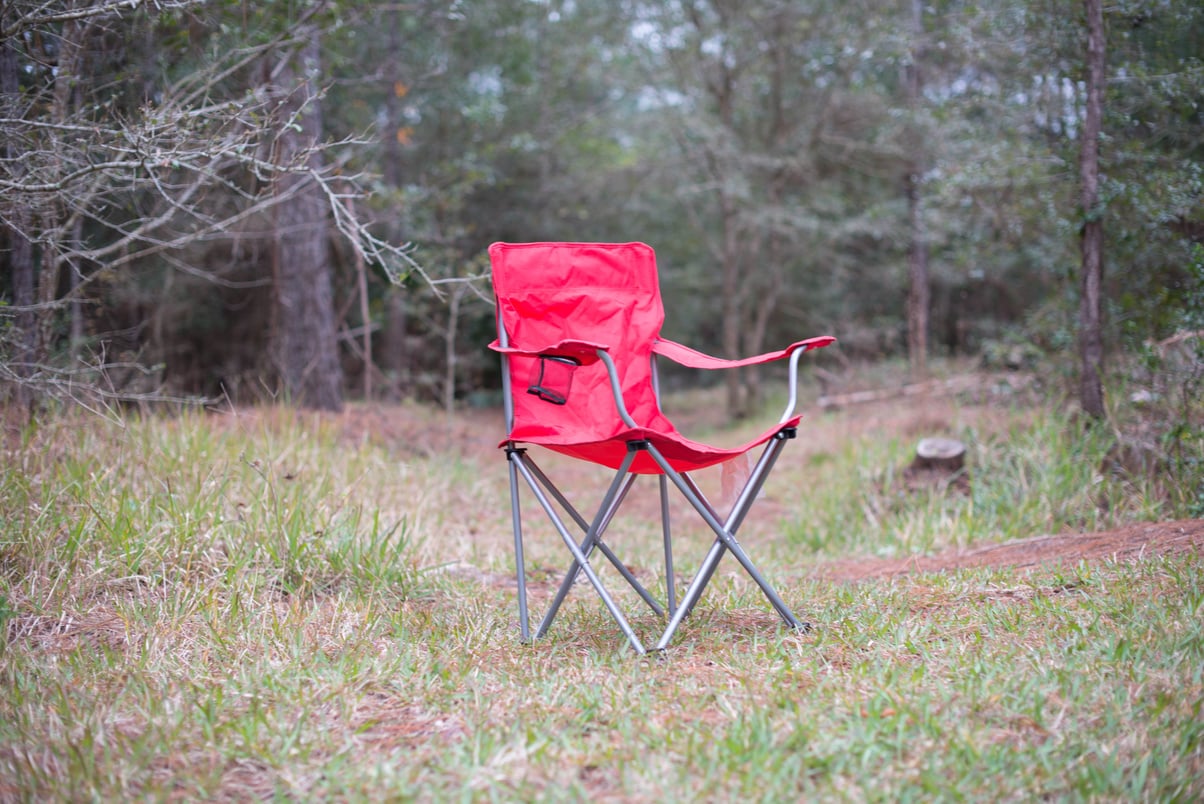 Red picnic chair on the forest